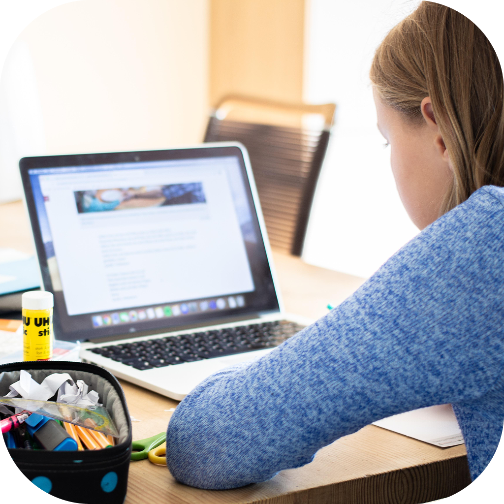 Image of young girl participating in a remote learning setting on her laptop.