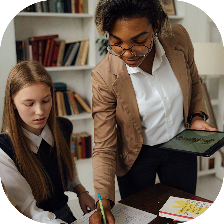 A teacher assisting a student on an assignment.